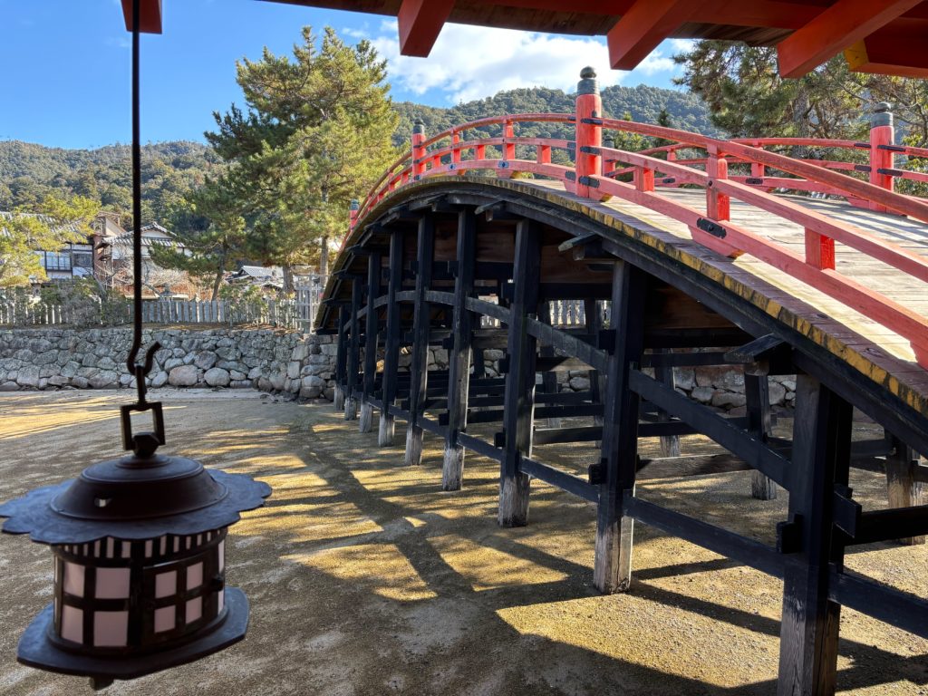 Scenic view of Itsukushima Shrine corridors with mountains in background