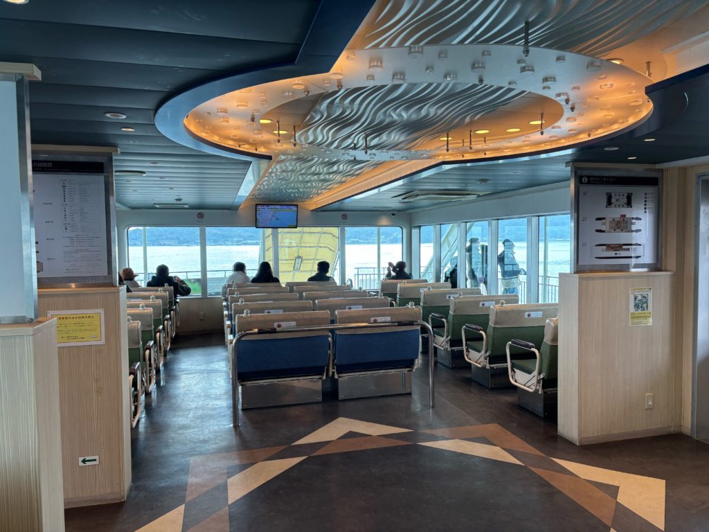 Interior cabin of Miyajima ferry with passengers seated