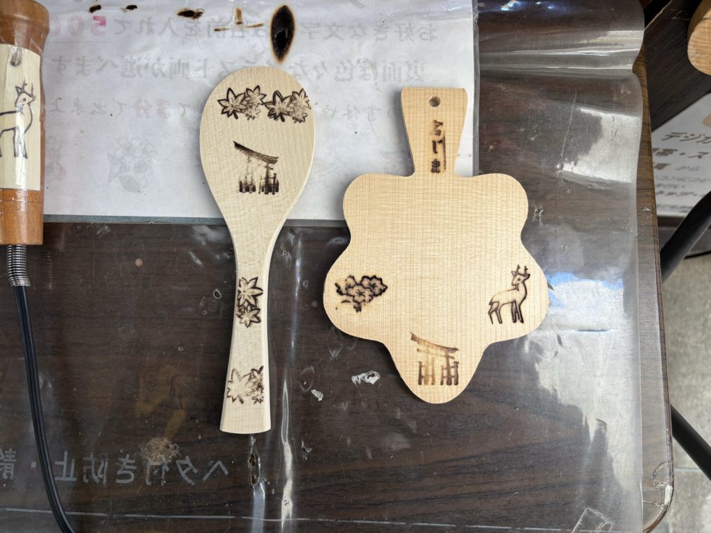 Completed branded rice paddle and maple leaf postcard showing traditional Miyajima motifs