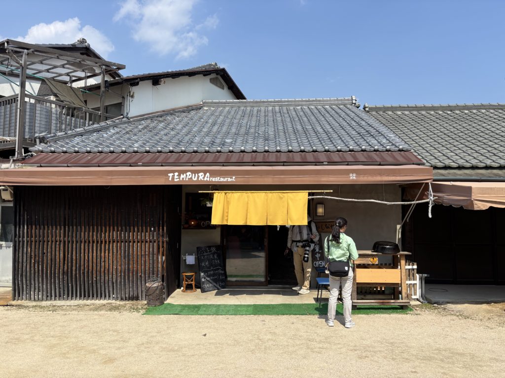 Mishinaya tempura restaurant exterior with yellow noren curtain in Miyajima