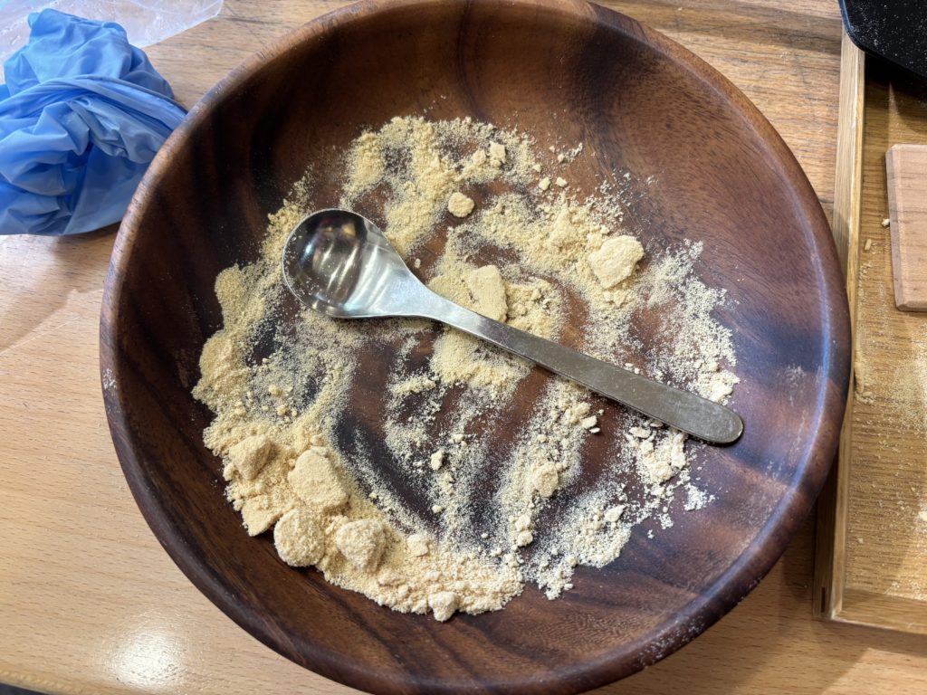 Pressing wasanbon sugar firmly into the wooden mold